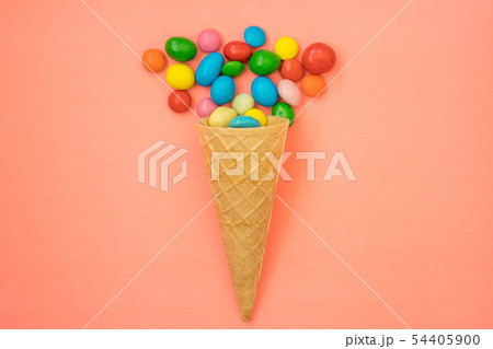 Waffle horn with candy on pink background 54405900