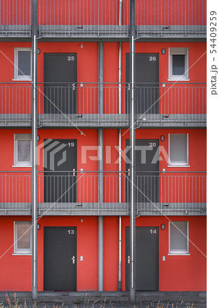 Building exterior with red walls and gray doors Building exterior with red walls and gray doors 54409259