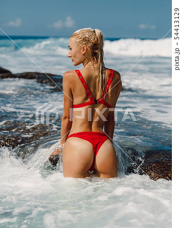 Young woman with perfect body posing in bikini 54413129