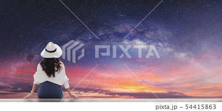 Woman with starry sky with milky way at dawn Woman with starry sky with milky way at dawn 54415863
