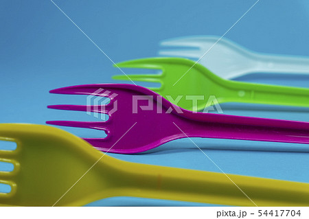 Colorful plastic forks on blue background 54417704