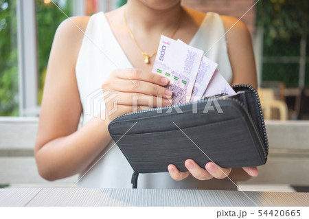 Asian women pick up Thai banknotes from the purse Asian women pick up Thai banknotes from the purse 54420665