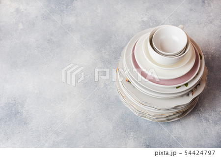 Stack of empty clean plates on a gray table Stack of empty clean plates on a gray table 54424797