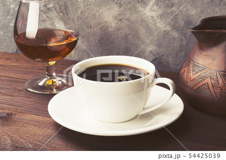 Coffee in white cup with cognac and clay cezve on Coffee in white cup with cognac and clay cezve on 54425039