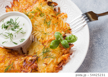 Fried cakes of grated potatoes on the plate  54425231