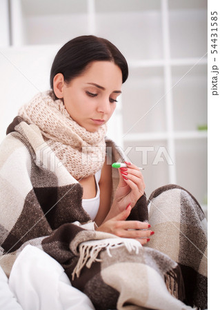 Flu. Young woman with cold flu lying on the bed 54431585