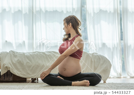 Asian Pregnant woman practice yoga in bedroom Asian Pregnant woman practice yoga in bedroom 54433327
