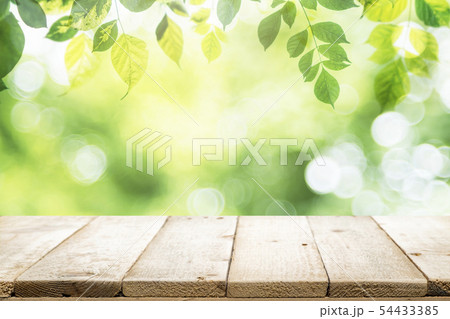 Empty table for present product with green bokeh Empty table for present product with green bokeh 54433385