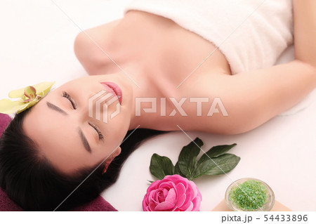 Beautiful Young Woman Getting a Face Treatment at Beauty Salon. 54433896