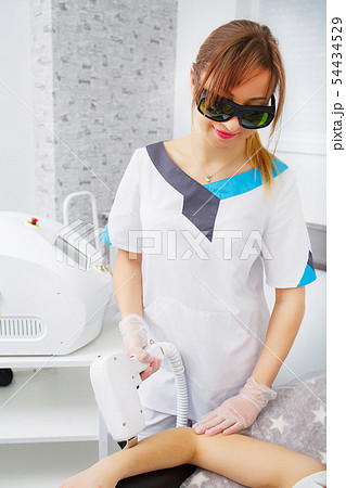 Woman having underarm Laser hair removal epilation 54434529