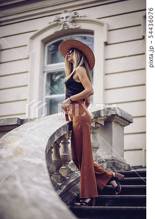 Noise. Vintage Style. Stylish woman in white hat standing on old town Noise. Vintage Style. Stylish woman in white hat standing on old town 54436076