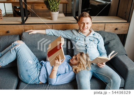 Love couple resting on comfortable couch at home Love couple resting on comfortable couch at home 54436329