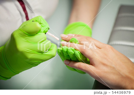 Manicure. Skillful master of manicure holding file in her hands while working in her beauty salon Manicure. Skillful master of manicure holding file in her hands while working in her beauty salon 54436979