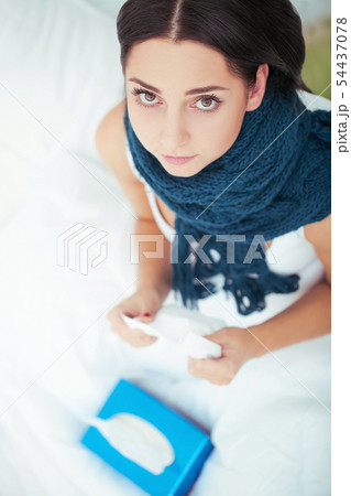 Beautiful caucasain woman is lying in bed and taking pill. Beautiful caucasain woman is lying in bed and taking pill. 54437078