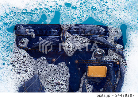 Jeans soak in powder detergent water dissolution. 54439387