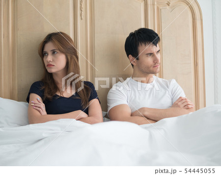 Upset young couple having problems in bedroom. Upset young couple having problems in bedroom. 54445055