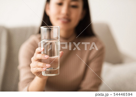 Asian Girl Holding Mineral Water In Glass 54446594
