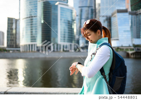 Portrait of young woman walking on the street, wearing cute trendy jacket. Portrait of young woman walking on the street, wearing cute trendy jacket. 54448801