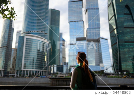 Portrait of young woman walking on the street, wearing cute trendy jacket. 54448803