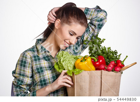 Young woman with vegetables and fruits in shopping Young woman with vegetables and fruits in shopping 54449830