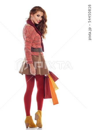 Young woman with shopping bags over white 54450816