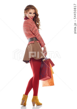 Young woman with shopping bags over white 54450817