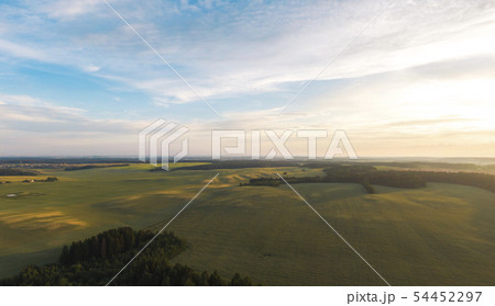Fields and forests at sunset. 54452297
