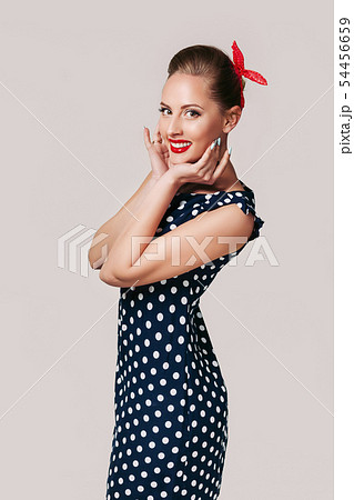 portrait of pin up woman in polka dot dress. 54456659