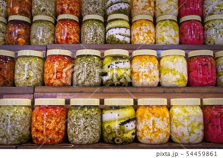 Jars with variety of pickled vegetables. 54459861