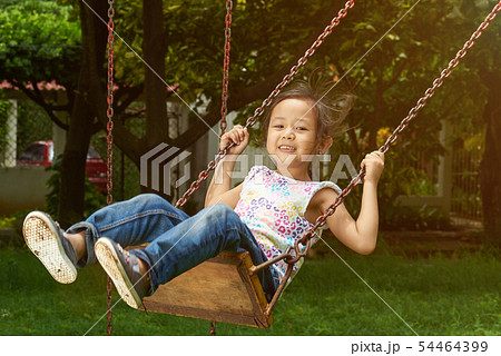 Asian girl smiling on a swing 54464399