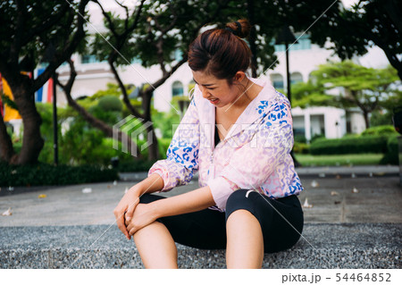 Young adult Asian woman having knee joint pain accident on jogging Young adult Asian woman having knee joint pain accident on jogging 54464852