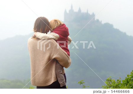 Young woman with little child admiring view of 54466666