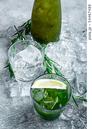 Estragon lemonade. Concept refreshing summer drinks. Fresh cool lemonade tarragon with ice and 54467489