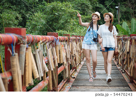 friends walk on wish wood bridge with bamboo tube friends walk on wish wood bridge with bamboo tube 54470243