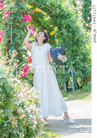 満開のバラ園 を楽しむミドル女性  薔薇のアーチ バラ 薔薇 花園 54471177