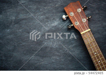 Ukulele on black cement background. Ukulele on black cement background. 54472405