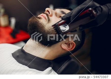 Stylish man sitting in a barbershop 54473307