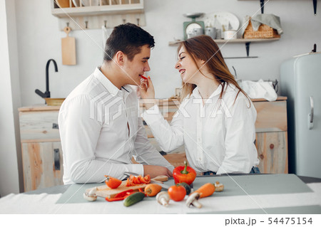 Beautiful couple prepare food in a kitchen 54475154