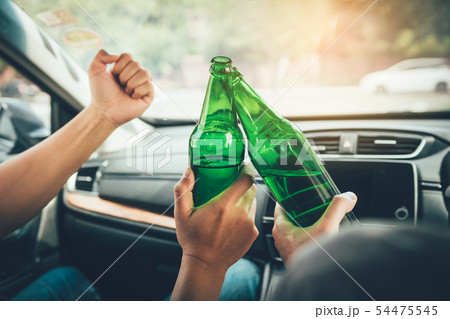 Two male friends are celebrating in the car while 54475545
