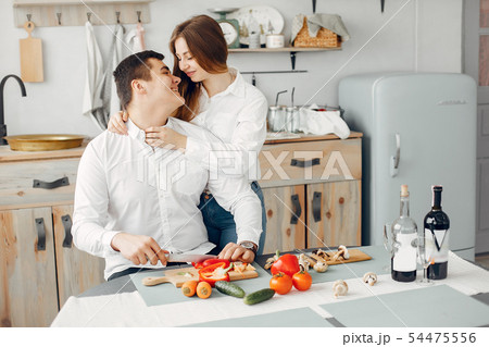 Beautiful couple prepare food in a kitchen Beautiful couple prepare food in a kitchen 54475556