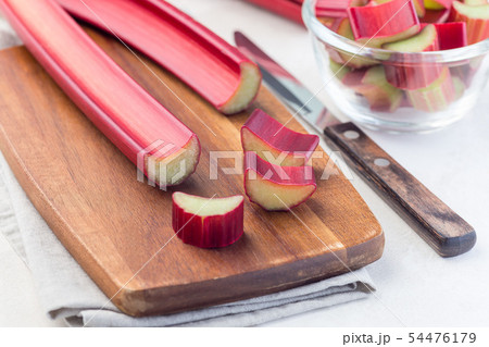 Cutted rhubarb on wooden board, horizontal Cutted rhubarb on wooden board, horizontal 54476179