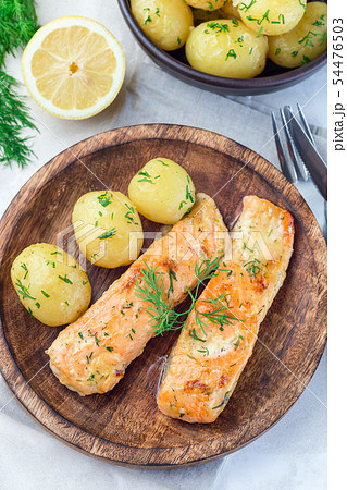 Baked salmon in creamy sauce with young potato Baked salmon in creamy sauce with young potato 54476503