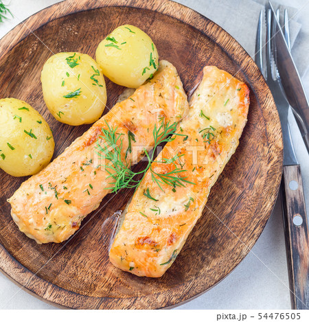 Baked salmon in creamy sauce with young potato Baked salmon in creamy sauce with young potato 54476505