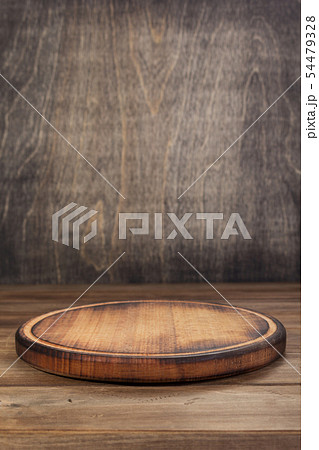 pizza cutting board at rustic wooden table 54479328