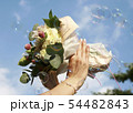 青空に映える真珠を付けた女性の手と花束 54482843