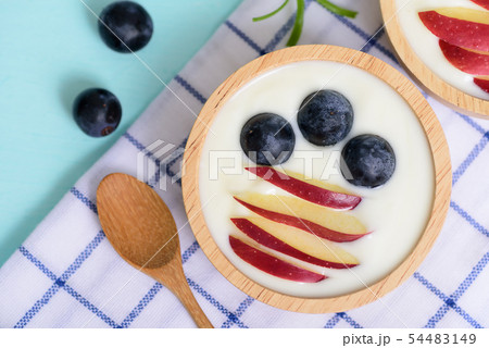 Yoghurt with apple and grape in a bowl Yoghurt with apple and grape in a bowl 54483149
