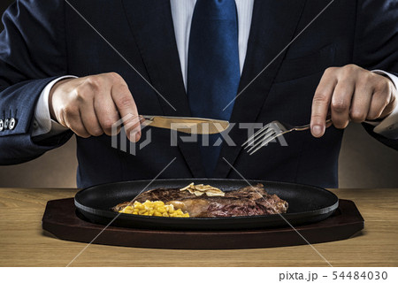 ステーキを食べるビジネスマン 54484030