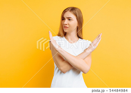 Young serious girl, arms crossed, showing a 54484984