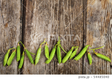 Pea pods on a wooden background. 54485040