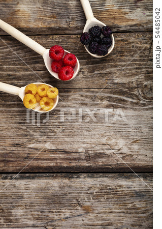 Ripe raspberry on an old wooden table. Ripe raspberry on an old wooden table. 54485042